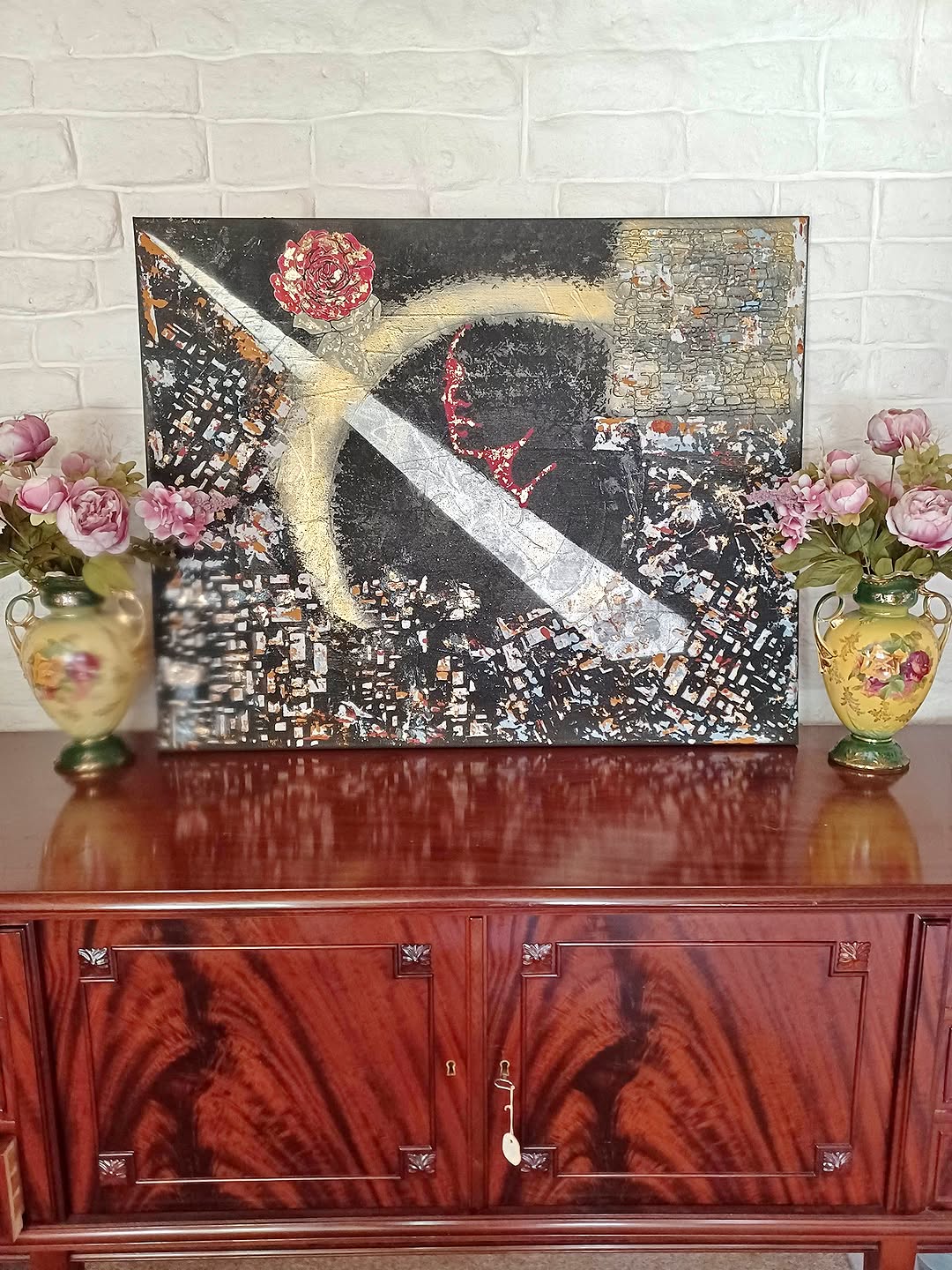 Abstrakt maleri med sort baggrund,guld diagonal og rød blomst, rød streg af dame og blad guld.